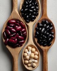 Poster - Overhead close up of assorted beans in wooden spoons food photography studio shot of kidney black and garbanzo beans
