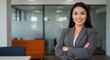 © Janitha - Professional Woman Smiling Confidently in Modern Office Environment