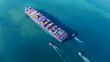 © Yellow Boat - Aerial top view of a large cargo ship fully loaded with colorful shipping containers navigating through calm ocean water. Ideal for logistics, transport, and global trade concepts.