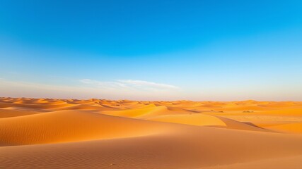 a breathtaking panoramic view of vast golden sand dunes under a vibrant clear blue sky du daytime.