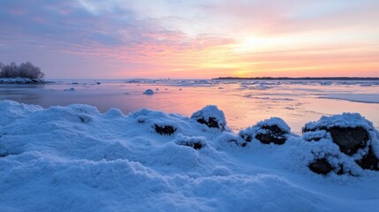 Aufkleber - Serene winter sunset over a frozen bay, snow-covered rocks in the foreground, reflecting the pink and purple hues of the twilight sky. : Generative AI