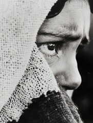 Poster - Close-up black and white portrait of a woman's pensive face partially obscured by a knitted shawl, conveying a sense of contemplation and quiet vulnerability. : Generative AI