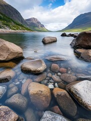 Aufkleber - Serene mountain lake scene with smooth, clear water revealing colorful rocks beneath the surface, majestic peaks reflecting in the calm waters. : Generative AI