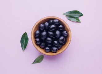 Aufkleber - A wooden bowl filled with glistening black olives is presented on a pale pink background, accompanied by several fresh green olive leaves. : Generative AI