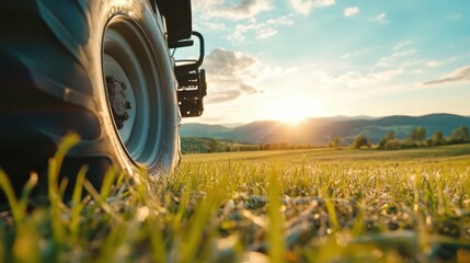 Poster - Close-up of a rugged tire on a farm vehicle, set against a vibrant sunset over rolling hills and a lush green field. : Generative AI