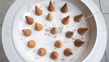 Poster - Artistic display of clay cones on white surface studio setting installation art minimalist environment aerial perspective contemporary concept