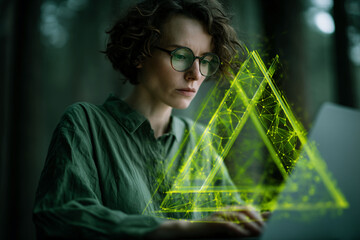 Poster - Woman with curly hair wearing glasses uses laptop, a glowing green triangle graphic overlays the scene, symbolizing technology, innovation, and digital connection