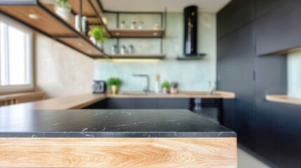 Aufkleber - Modern kitchen island countertop with black marble and light wood, showcasing a blurred background of sleek cabinetry and open shelving. : Generative AI