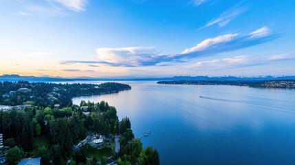 Poster - Aerial view of a serene lake at sunset, with houses nestled along the shoreline and distant mountains under a vibrant sky.  The tranquil water reflects the colorful clouds. : Generative AI