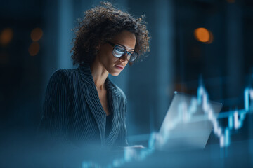 Poster - Focused businesswoman with curly hair works late on laptop, analyzing data charts, showcasing dedication and professionalism in business