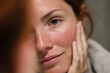 © SMK - Redhead Woman's Face with Rosacea and Freckles, Natural Skin, Looking at her Reflection in a Mirror, Touch