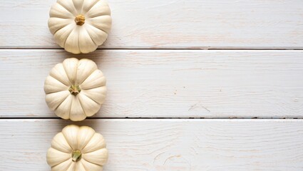 Poster - Three pumpkins on a white surface.