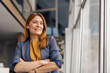 © Dusan Petkovic - Portrait of confident professional businesswoman standing at corporate firm with arms crossed and looking through the window.