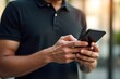 © Shah - Man Using Smartphone Outdoors in Sunny Urban Setting – Casual Lifestyle Photo Highlighting Digital Connectivity and Daily Interaction