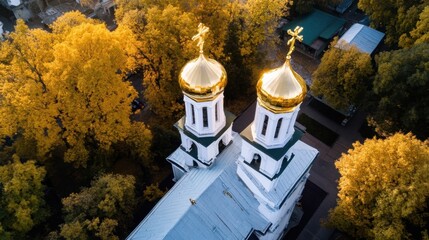 Poster - Aerial view of a church with golden domes surrounded by autumn trees, showcasing vibrant yellow foliage and a tranquil atmosphere. : Generative AI