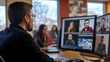 © ziya - Photograph of a man on a video call with colleagues visible on multiple computer screens in an office setting.