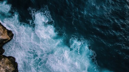 Aufkleber - Aerial view of ocean waves crashing against a rocky cliff, showcasing a dramatic contrast between the deep blue water and the white foam. : Generative AI