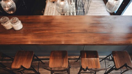 Aufkleber - Overhead view of a rustic wooden bar counter with four wooden stools and glass sugar containers. : Generative AI