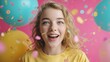 © Alicia - Young woman smiles with balloons and confetti against a pink background.