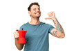 © luismolinero - Brazilian man holding coffee pot over isolated chroma key background proud and self-satisfied