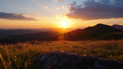 Poster - Golden sunset over a vast mountain range, casting long shadows across the grassy landscape. A foreground rock adds texture to the serene scene. : Generative AI