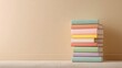 © Isolated studio - Stack of Pastel Colored Books on Beige Floor with Neutral Background