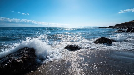 Aufkleber - Ocean waves crashing against dark rocks on a sunny beach, creating a vibrant, sparkling scene under a clear blue sky. : Generative AI