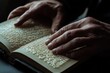 © Volodymur - A close-up of hands turning pages of a braille book, showing the texture and interaction of touch reading, highlighting accessibility