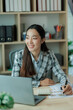 © Wanchai - Professional female accountant reviewing annual expense reports at her desk with a laptop and paperwork — ideal for finance, tax, and corporate business themes.