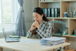 © Wanchai - A frustrated female accountant sits at her desk, reviewing financial documents with visible stress — ideal for themes of accounting pressure, deadline anxiety, and workplace burnout.