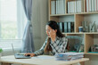 © Wanchai - A frustrated female accountant sits at her desk, reviewing financial documents with visible stress — ideal for themes of accounting pressure, deadline anxiety, and workplace burnout.
