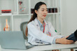 © Wanchai - Female healthcare worker checking an elderly patient’s vital signs indoors, showing compassionate support and the importance of senior health and wellness.