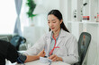© Wanchai - Female healthcare worker checking an elderly patient’s vital signs indoors, showing compassionate support and the importance of senior health and wellness.