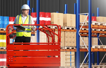 Poster - Man inside warehouse building. Worker in cart of warehouse lift. Builder of storage enterprise. Man warehouse hangar designer. Construction worker in yellow vest near storage shelving.