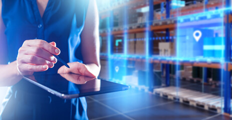 Poster - Electronic tablet in hands of warehouse employee. Woman with electronic gadget is doing fulfillment. Manager manages warehouse via e-tablet. Storage technology concept. Warehouse software