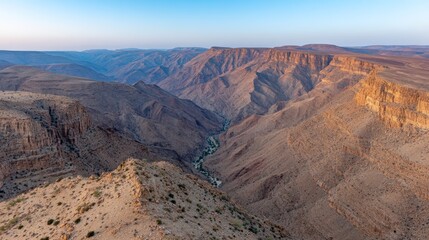 Aufkleber - Vast rugged terrain in a desert at sunset reveals a narrow creek winding through cracked earth, highlighting serene natural beauty with expansive sky above