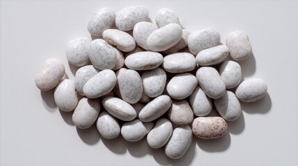 Poster - Close-up view of soft beans neatly positioned against a seamless white backdrop, showcasing their shapes and subtle shadows that enhance the details