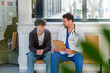 © Halfpoint - Doctor talking with teenage patient in hospital waiting room.