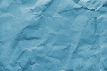 Recycled crumpled blue colored paper texture. Wrinkled craft paper background, rough cardboard surface, wallpaper, backdrop. Design element, copy space for text
