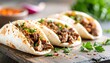 © Chatchawan - Delicious Spicy Beef Tacos Served on Wooden Board Closeup of flavorful street food