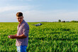 © zorandim75 - Farmer using drone technology for smart agriculture in green field