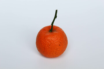 Fototapete - One small orange with stem, isolated on white background