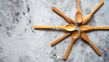 Poster - Artistic arrangement of wooden spoons on textured surface kitchen decor still life top view minimalistic design