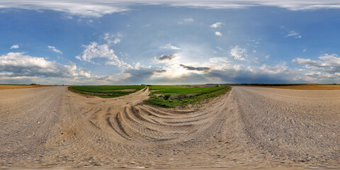 Wall Mural - hdri 360 panorama view on gravel muddy road among fields at evening with flock of birds in clouds in