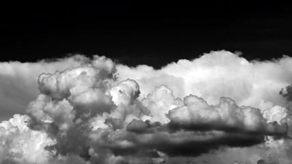 Wall Mural - time-lapse of separate white clouds on a black background have real clouds. time-lapse of white fluffy cumulus cloud isolated