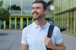 © ajr_images - Handsome elegant man walking outdoors with a backpack