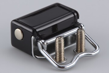 Poster - Close-up view of a black paper stapler resting on a smooth surface showcasing its metal components and sleek design