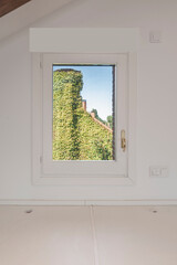 Poster - an attic window overlooking a facade with vines covering a chalet