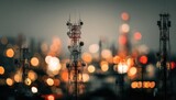 Telecommunication towers with blurred urban background at night