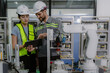 © Nassorn - Group of hispanic people working on robot programming in robotic and electronic engineering laboratory. Latino engineer team learning and research automated machine with intelligent mechanical control